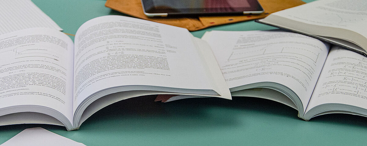 Books lying open on a table